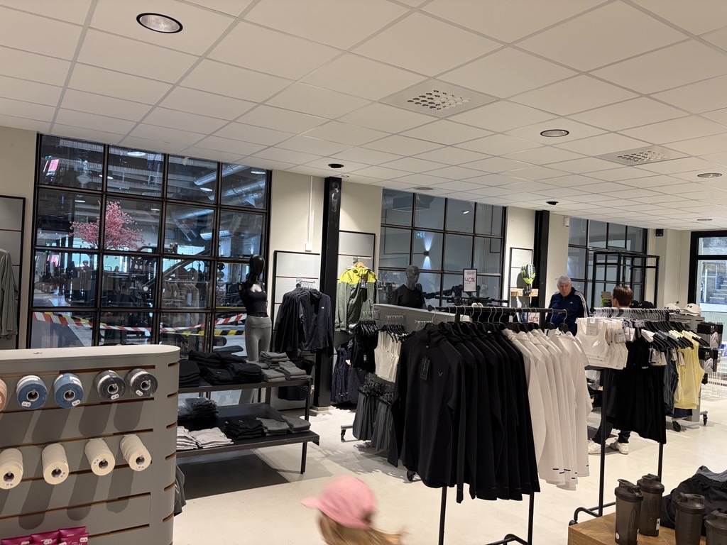 Sortiment av kläder med gymmet i bakgrunden